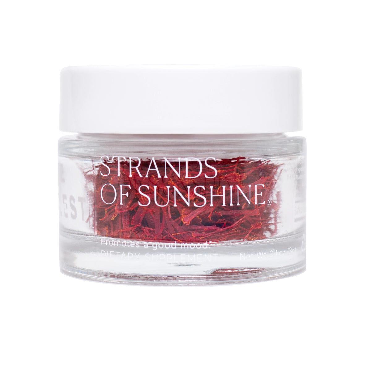 A clear glass jar with a white lid labeled "Saffron Threads" by THE FULLEST, containing vibrant red saffron threads.