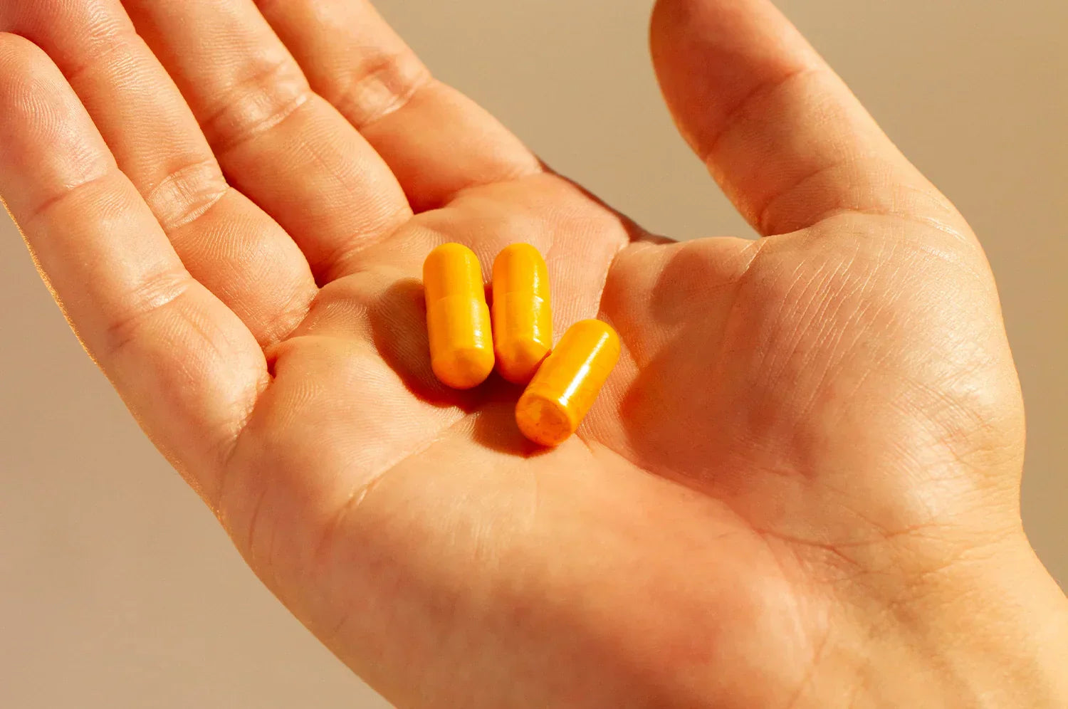 Saffron capsules in a hand in bright lighting