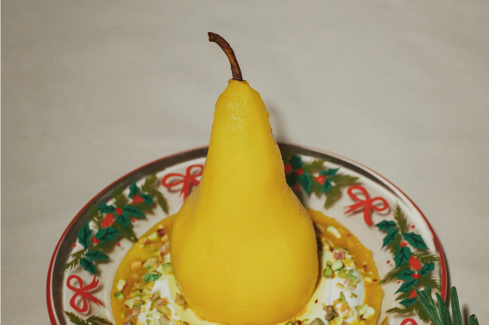 Saffron poached pear in a Christas dish with natural lighting