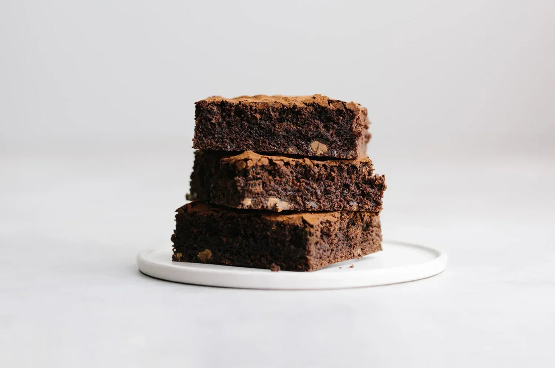 Saffron Brownies stacked on a white ceramic plate 