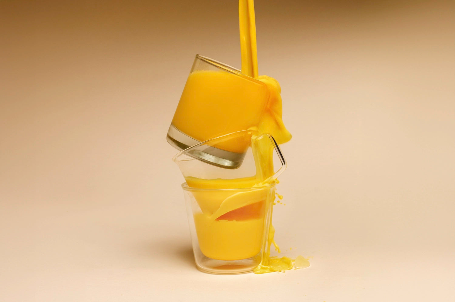 Three stacked glasses overflowing THE FULLEST's Warm Feelings saffron latte.