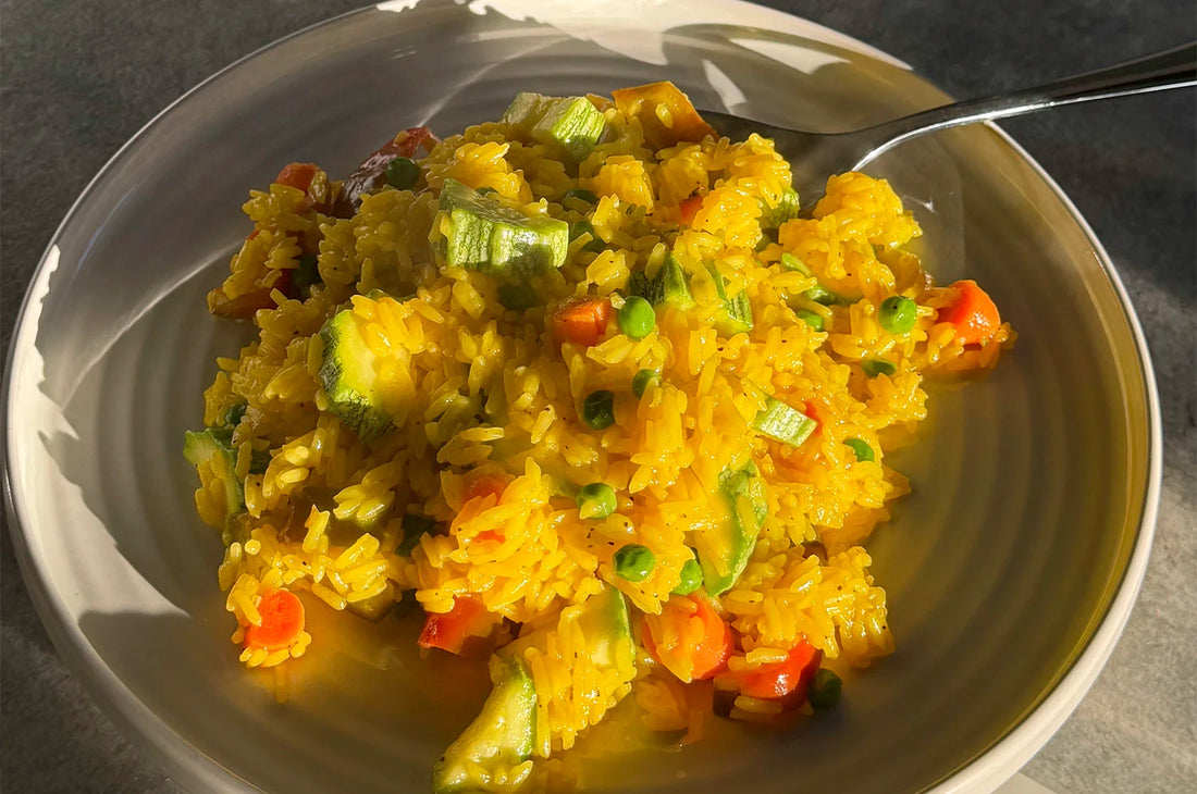 A plate of saffron rice with veggies prepared with THE FULLEST's Warm Feelings saffron latte.