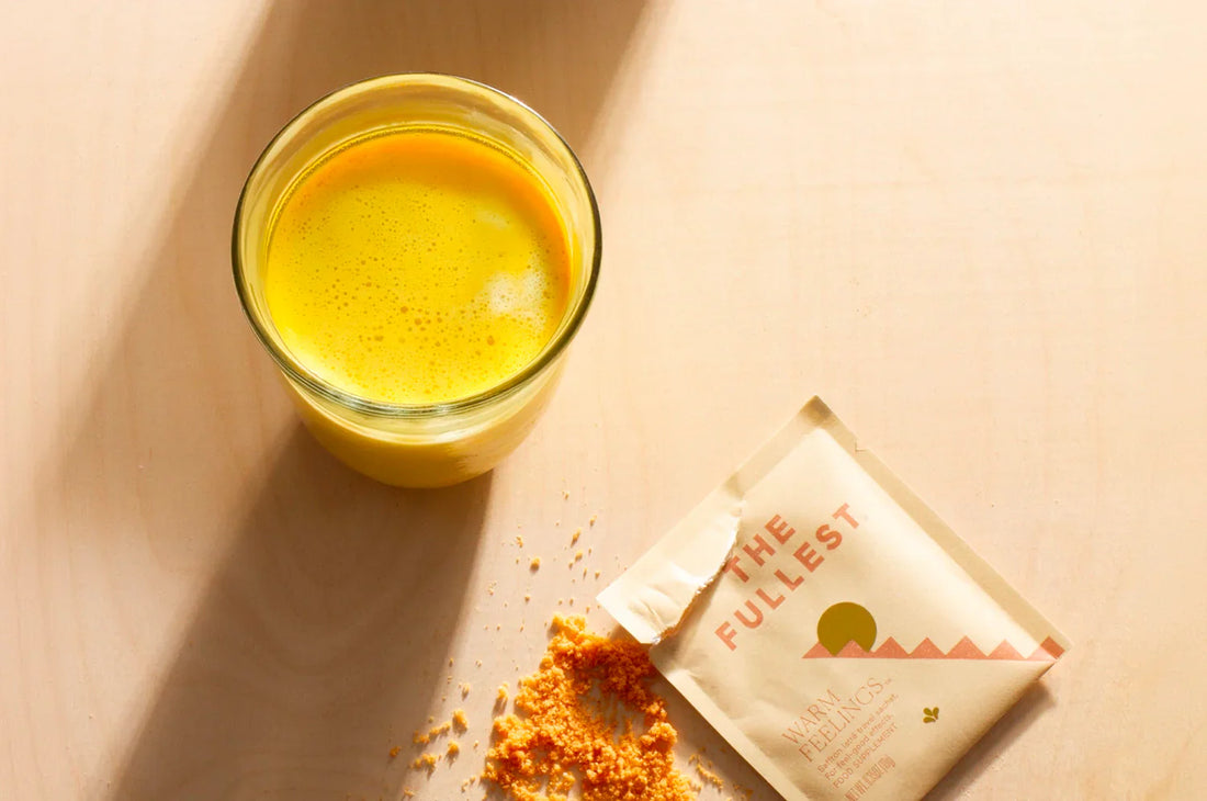 A man sipping THE FULLEST Saffron Latte on ice in a yellow t-shirt.