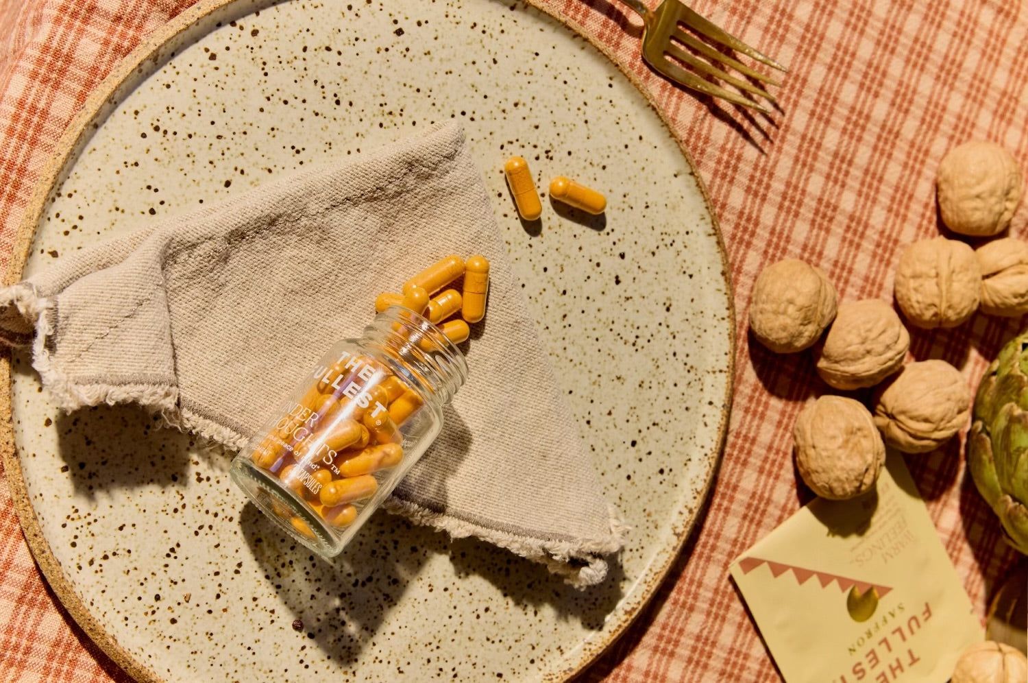 Kinder Thoughts capsules spilled onto a fall plate setting