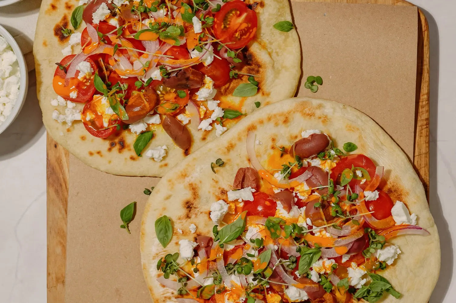 Mediterranean Tomato + Feta Flatbread with Kinder Thoughts® Saffron Olive Oil Drizzle