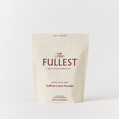 A beige resealable pouch labeled "THE FULLEST Saffron Latte 30-Day Supply," 15.9 oz (300g), is displayed against a plain white background, highlighting this delicious saffron latte blend renowned for its mood support and anxiety relief benefits.