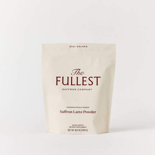 A beige resealable pouch labeled "THE FULLEST Saffron Latte 30-Day Supply," 15.9 oz (300g), is displayed against a plain white background, highlighting this delicious saffron latte blend renowned for its mood support and anxiety relief benefits.