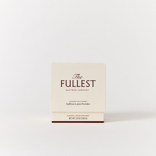 A box labeled "Saffron Latte 10 Single-Serving Sachets" from THE FULLEST is centered against a plain white background, highlighting this caffeine-free saffron latte that offers gentle mood support.