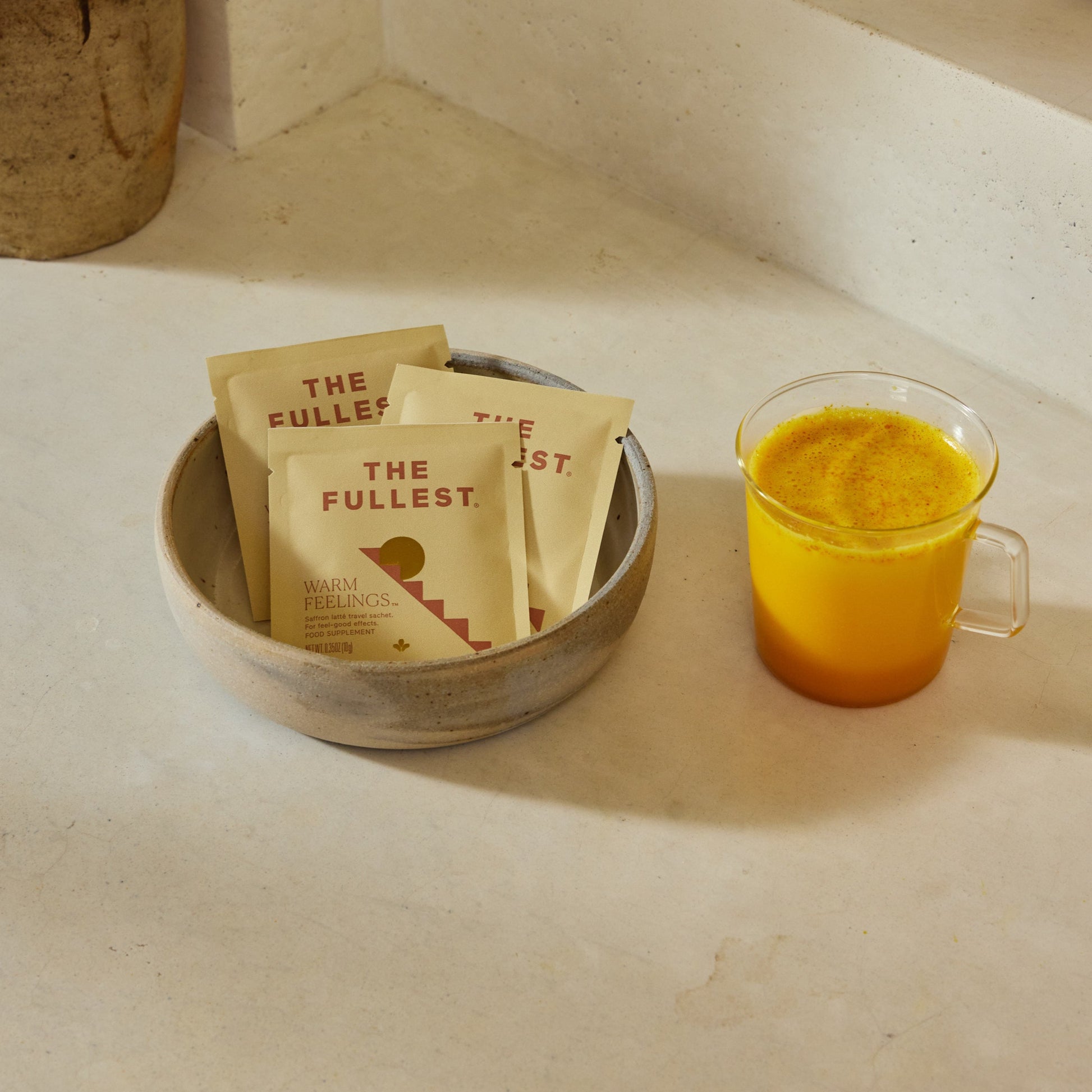 A ceramic bowl holds three "THE FULLEST" Saffron Latte Sachets (3-Day Supply, 100% off), next to a clear mug with a yellow-orange drink—perfect for highlighting Secomapp's BOGOS or Buy X Get Y offers.