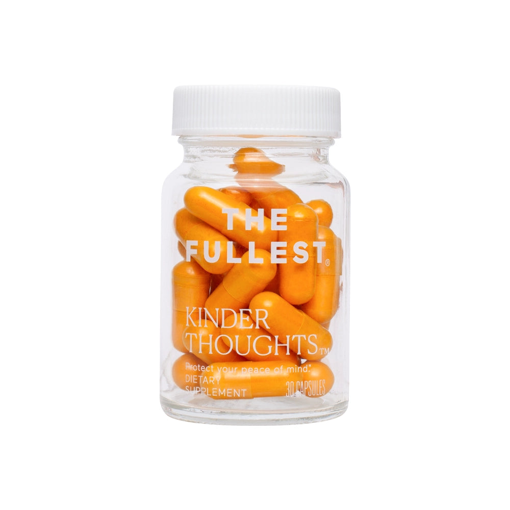 Transparent supplement bottle labeled &quot;THE FULLEST Kinder Thoughts&quot; containing orange curcumin capsules, isolated on a white background.
